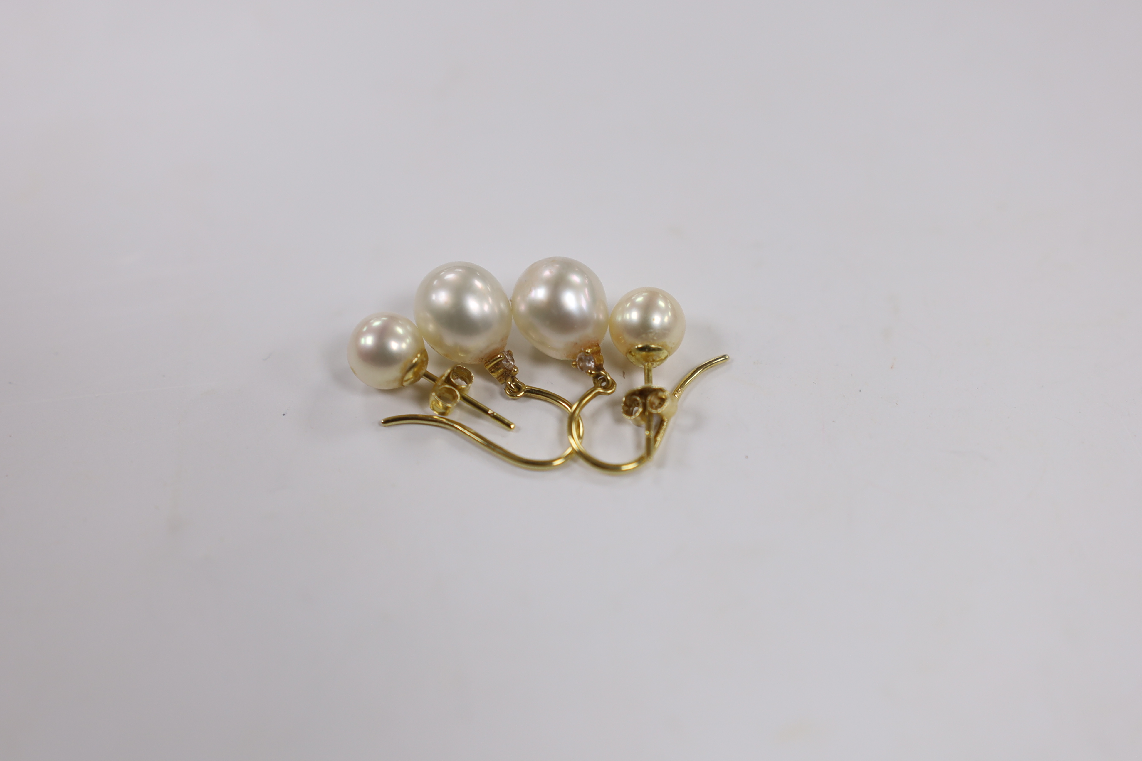 A pair of 18ct gold and cultured pearl and diamond chip set drop earrings and a pair of 18k and cultured pearl set ear studs.